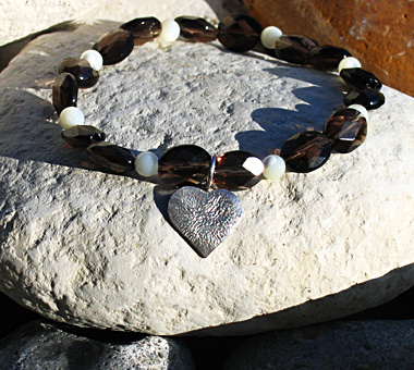 Sterling silver heart bracelet on elastic with smoky quartz and mother of pearl